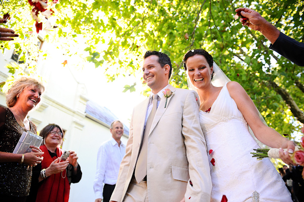 happy couple, bride and groom, ceremony exit, wedding photo by Eric Uys Photography